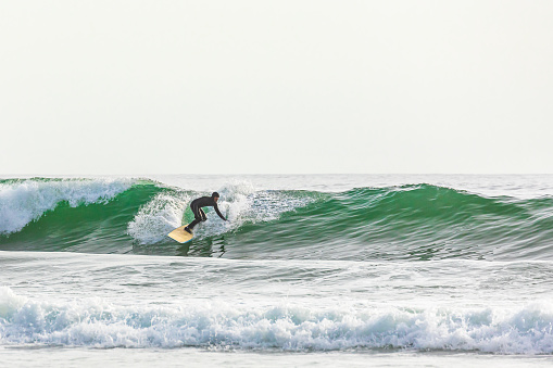 Sydne, Australia – July 08, 2022: A professional surfer catching waves at Bondi Beach in Australia