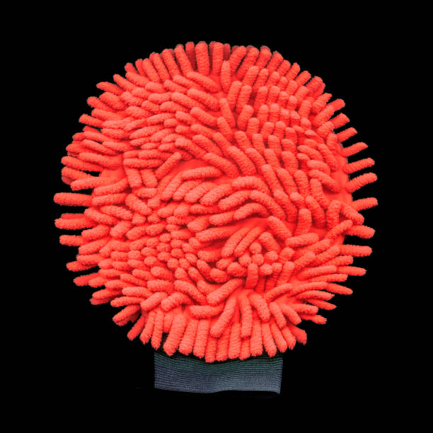 istock Red microfiber dusting glove programly deformed to round shape and looks like giant virus COVID-19. Close-up on black background. 1337911362