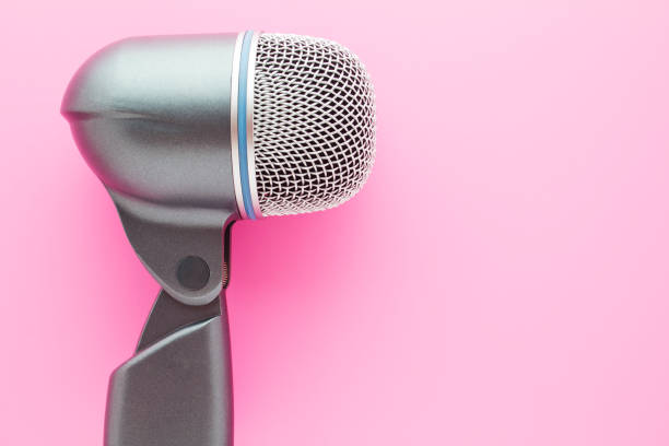 Big vocal microphone on bright pink background. stock photo