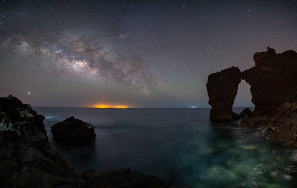 istock Milky way in a stone arch that falls over the sea 1337911905