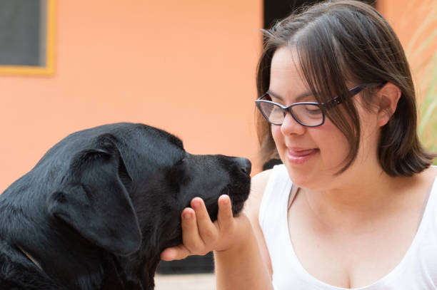 Young woman with Down syndrome caressing dog