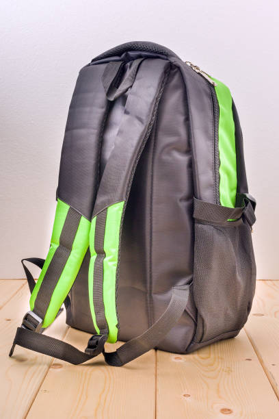 istock schoolbag empty black on wooden background 1337915619