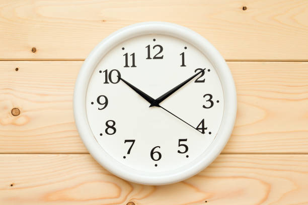 istock round wall clock on wooden background 1337916744