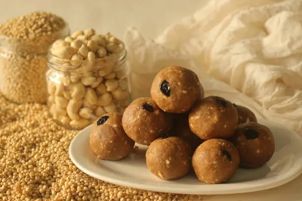 Sorghum sweet balls with jaggery, cashew nuts and raisins. Commonly know as Jowar laddu in India. Shot on white background.
