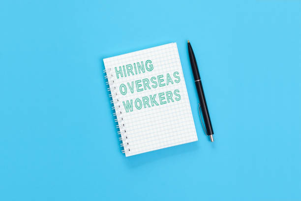 istock The text Hiring overseas workers is written on a notebook page 1337918667