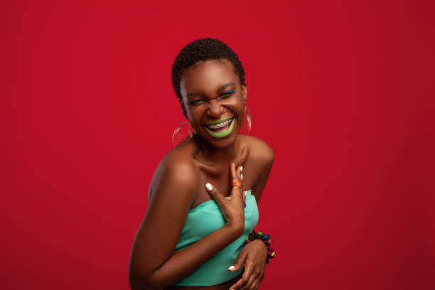 istock Effective african american young woman laughing on red studio background 1337920000