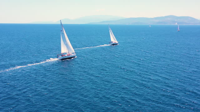 Group of sailboats sailing over beautiful sea. Aerial view
