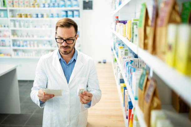 istock Young man pharmacist reading prescription medication box 1337920441