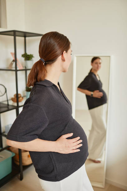 istock Pregnant Woman Looking In Mirror 1337921529