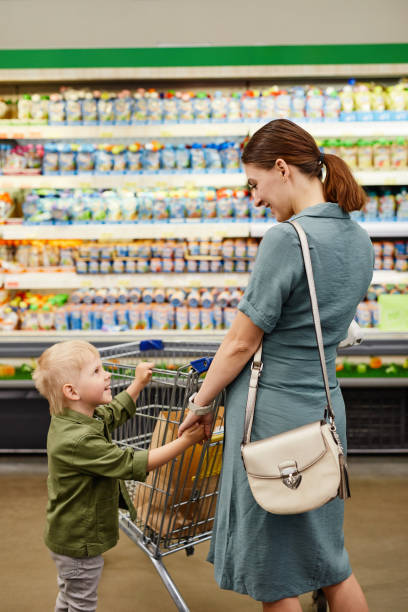 istock Mother With Son In Shop 1337921546