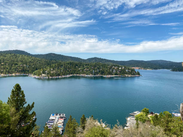 istock Wide angle view overlooking large mountain lake with marina and blue sky cloudscape 1337921562