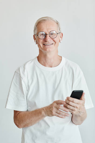 istock Smiling Senior Man with Smartphone 1337921723