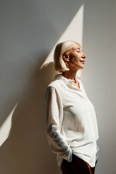 istock Elegant Mature Woman Lit by Sunlight 1337921750