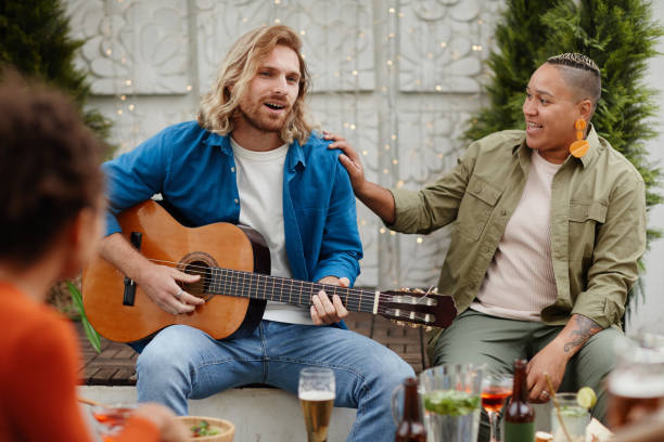 istock Young People Playing Guitar at Rooftop Party 1337922255