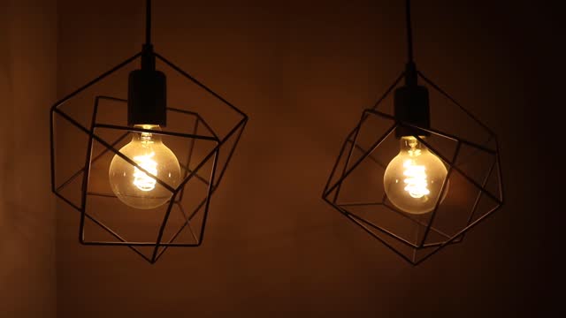 Lamps with bulbs swaying from the celling