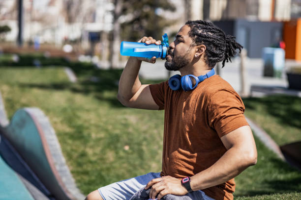 istock Young sportsman taking a break and drinking water 1337926151