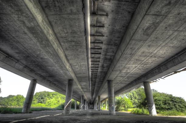 Concrete bridge Sub-view of a motorway concrete bridge construction material torn run down concrete stock pictures, royalty-free photos & images