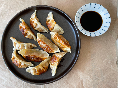 cooked gyoza or jiaozi with teriyaki sauce