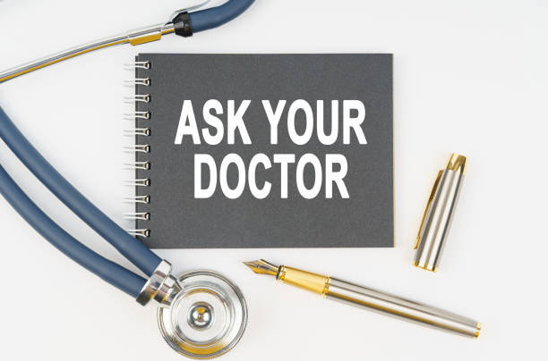 istock On a white background lie a stethoscope, a pen and a notebook with the inscription - ASK YOUR DOCTOR 1337934134