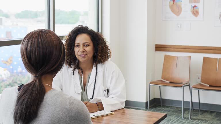 Attentive female doctor answers patient's questions