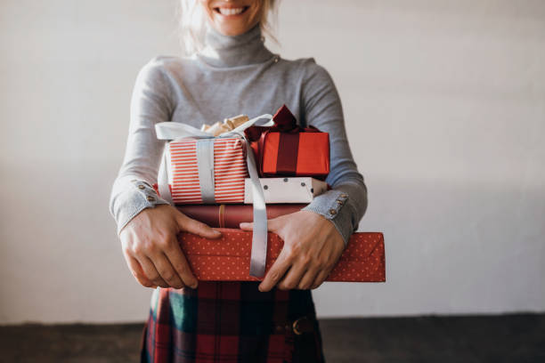 istock An Anonymous Woman Holding Christmas Presents in her Hands 1337936855