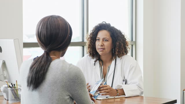 Doctor discusses healthcare options with senior female patient