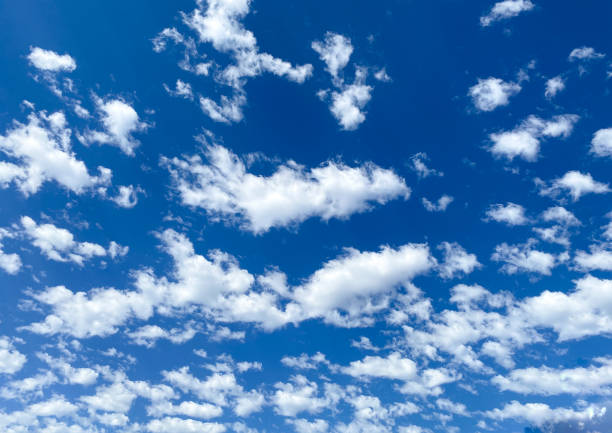 istock bright white fluffy clouds in the blue sky as overcast sunny high noon day scene 1337938451