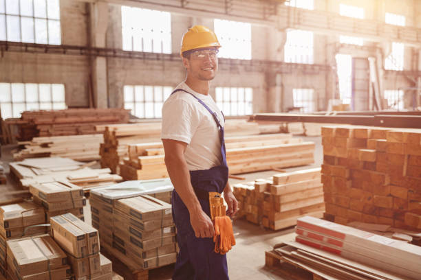 istock Cheerful male worker standing by construction materials 1337943570