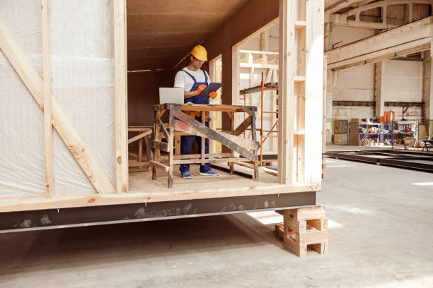 constructor masculino escribiendo en el portapapeles en el sitio de construcción - prefabricate fotografías e imágenes de stock