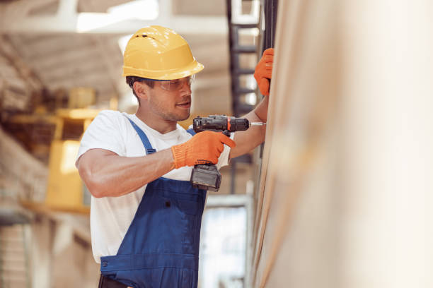 istock Male worker using cordless electric drill at construction site 1337943605