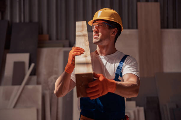 istock Handsome man carrying timber wood plank at construction site 1337943736
