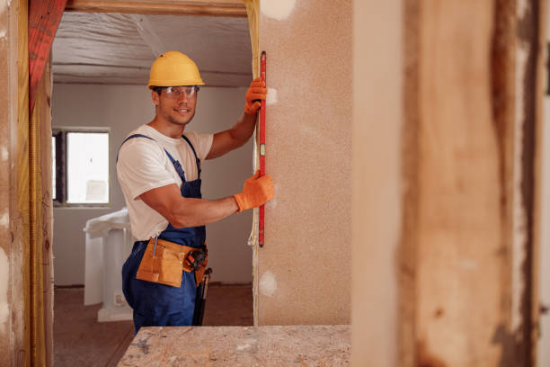 istock Cheerful male worker measuring wall in house 1337944330