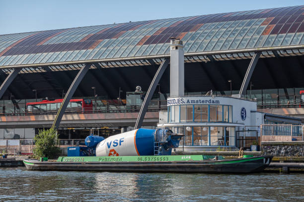 barge with cement mill docked on ij river, amsterdam, netherlands - voyagers imagens e fotografias de stock