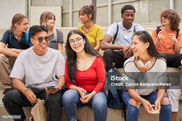 Group Of Multiethnic Students Happily Looking At The Camera During A Break Stock Photo - Download Image Now