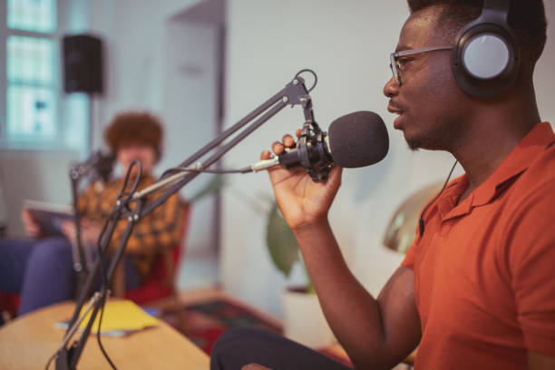 Welcome to our podcast Portraying two businessmen in recording session. They're streaming their talk live to the listeners interested in hearing about their experience and a word of advice. radio dj stock pictures, royalty-free photos & images