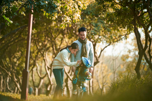 istock asian mother and father enjoying leisure activity outdoors in park 1337962790