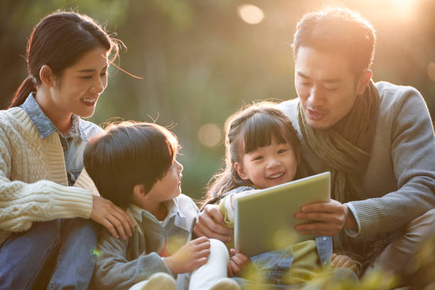 istock asian family with two kids enjoying outing in park 1337962802