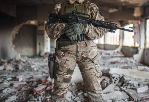 istock Special forces woman soldier with gun in war zone 1337964573