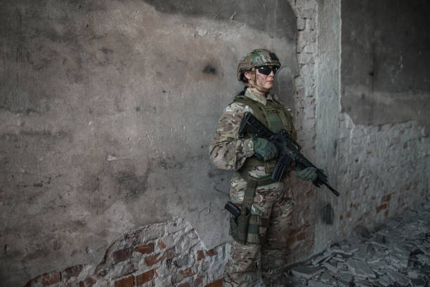 istock Young female army soldier wearing military uniform in war zone in abandoned warehouse 1337972704