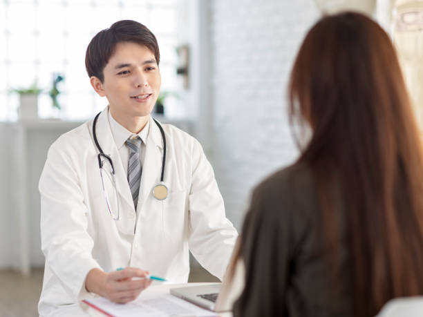 istock Young doctor talking to patient. 1337974922