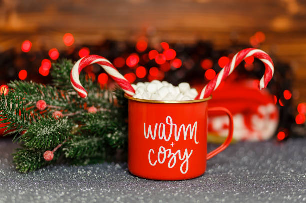 istock Cup of hot chocolate with marshmallows and red candy cane. 1337977432