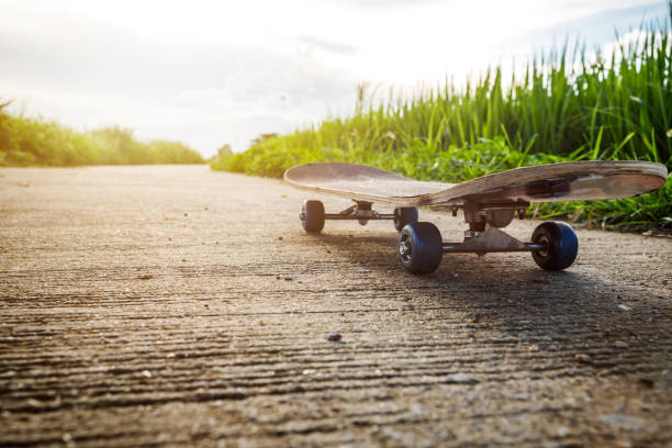 istock Close up skateboards laid out on concrete roads with fields background. 1337983520