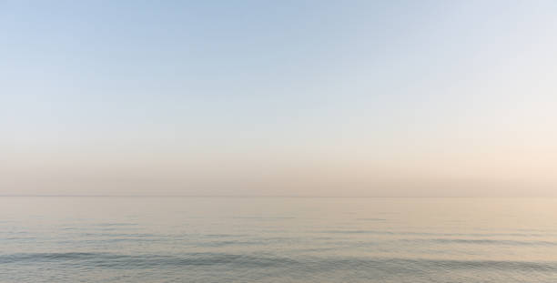 istock Calm evening sea surface with clear blue sky. Evening seascape. 1337988570