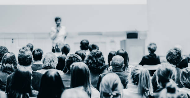 istock Woman giving presentation in lecture hall at university. 1337988591