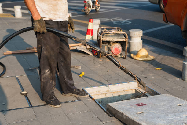 istock A worker is preparing to put the point cable into the underground passage 1337995583
