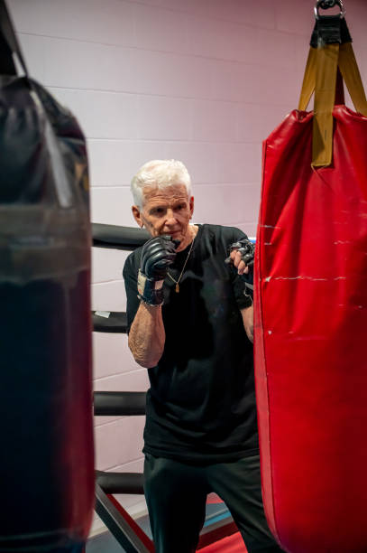 istock 80 year old male keeping fit with boxing training. 1337996347