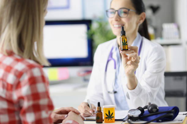 doctor shows patient bottle of marijuana oil - narcotic medicine pill insomnia imagens e fotografias de stock