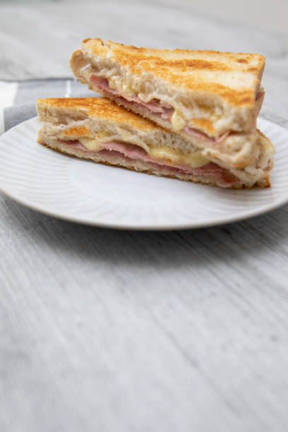 istock Toasted ham and cheese sandwich on a plate with a napkin 1337999198