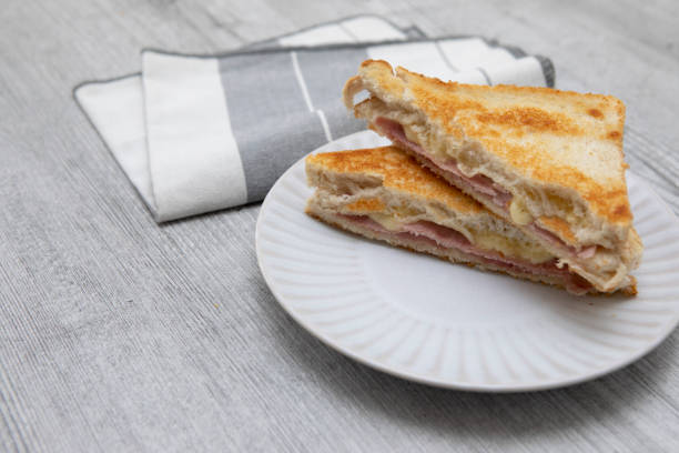 istock Toasted ham and cheese sandwich on a plate with a napkin 1337999206