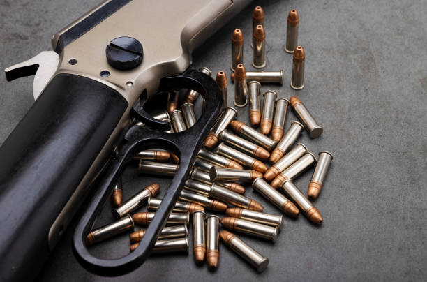 istock Classic gun , .22 Lever action rifle gun with bullets on texture background 1338000038